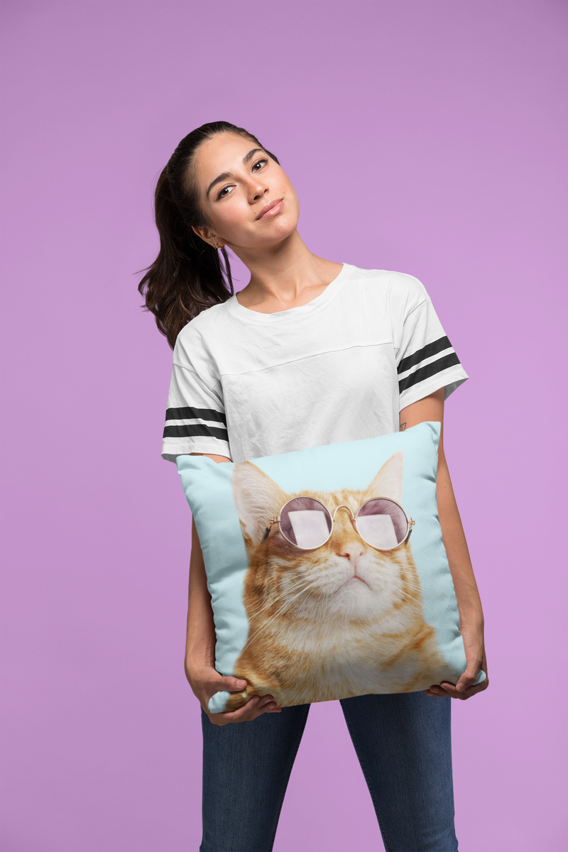 Full-body image of woman posing with humorous cat throw pillow for pet lovers