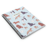 Flat lay of dog-themed spiral notebook with playful canine illustrations