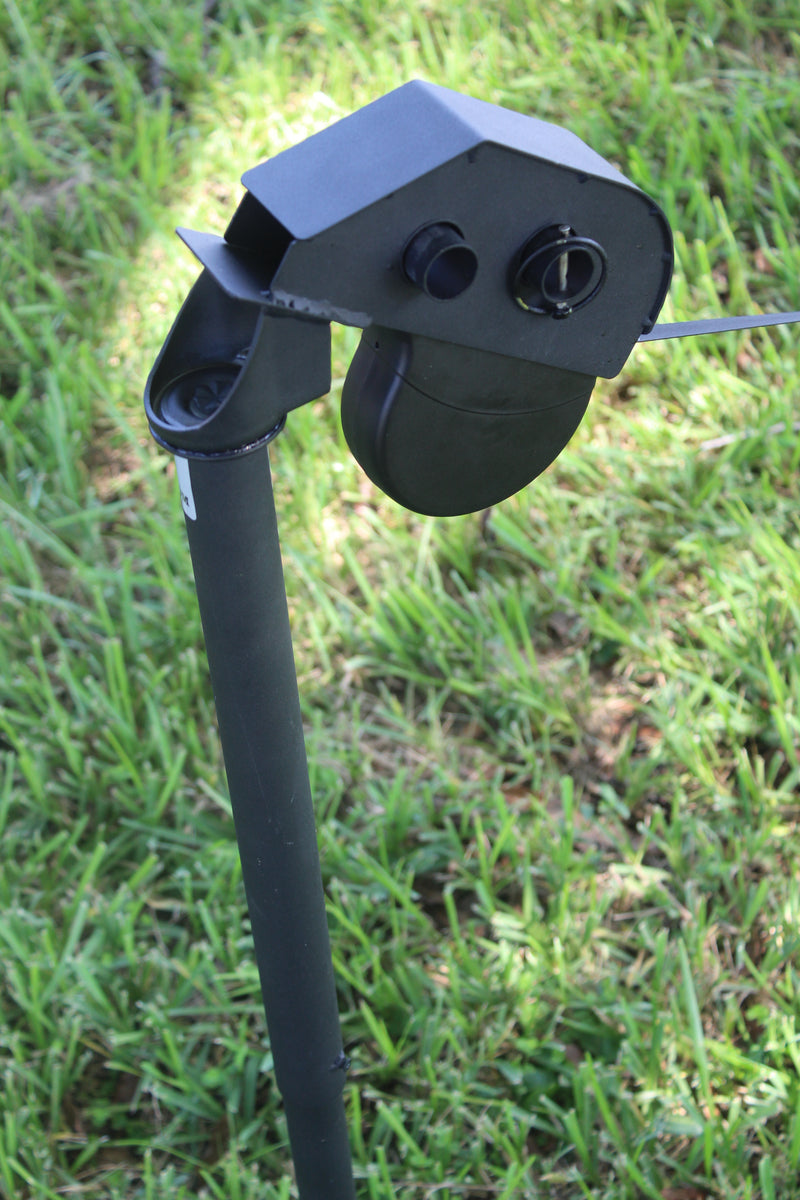 Angled top-down view of DogKeeper leash holder installed in grassy area