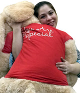 Woman hugging oversized Valentine’s stuffed puppy with love message